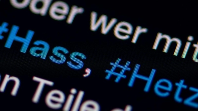 Auf dem Bildschirm eines Smartphones sieht man die Hashtags Hass und Hetze in einem Twitter-Post. (Foto: Fabian Sommer/dpa)
