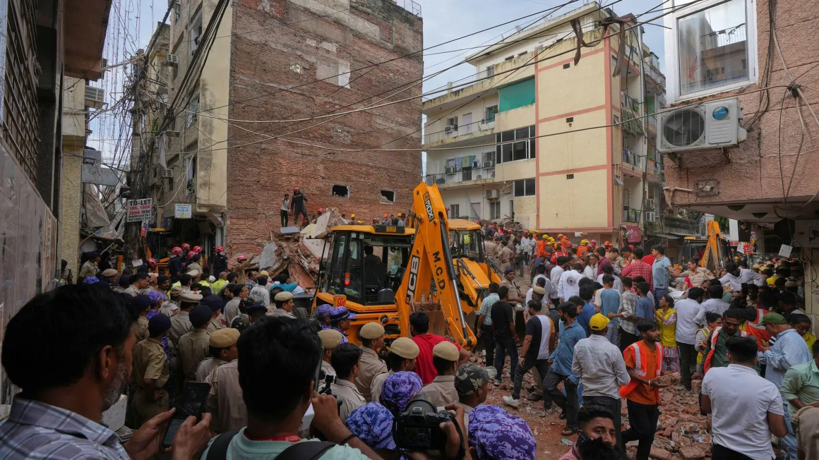 Rettungskräfte suchen in Neu-Delhi unter den Trümmern eines eingestürzten Gebäudes nach Überlebenden. (Foto: Rajesh Kumar Singh/AP/dpa)