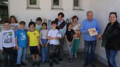 Blick in die Geschichte: die Leiterin der Grundschule Hennenbach, Karin List-Engerer, sowie Werner Finsterer, Ulrike Finsterer und Willy Finsterer (von rechts) mit Schülern aus der Grundschule Hennenbach haben sich mit der lange zurückliegenden Zeit befasst. (Foto: Alexander Biernoth)
