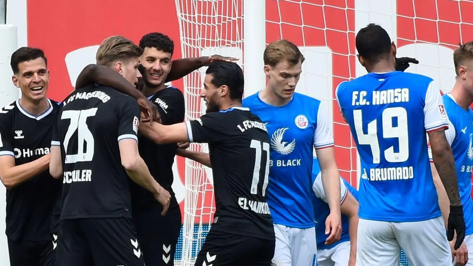 Die Magdeburger Spieler bejubeln ihr zweites Tor in Rostock. (Foto: Gregor Fischer/dpa)