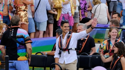 Der niederländische Ministerpräsident Rob Jetten steht auf einem Boot und winkt während der Canal Parade in Amsterdam. (Foto: Patrick Post/AP/dpa)