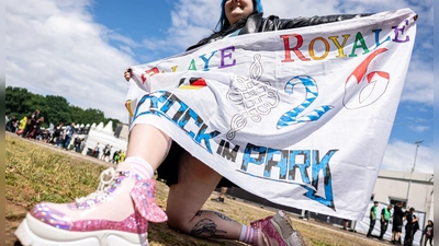 Ausgefallene Hüte und Outfits sind für viele Musikfans ein Muss.  (Foto: Daniel Karmann/dpa)