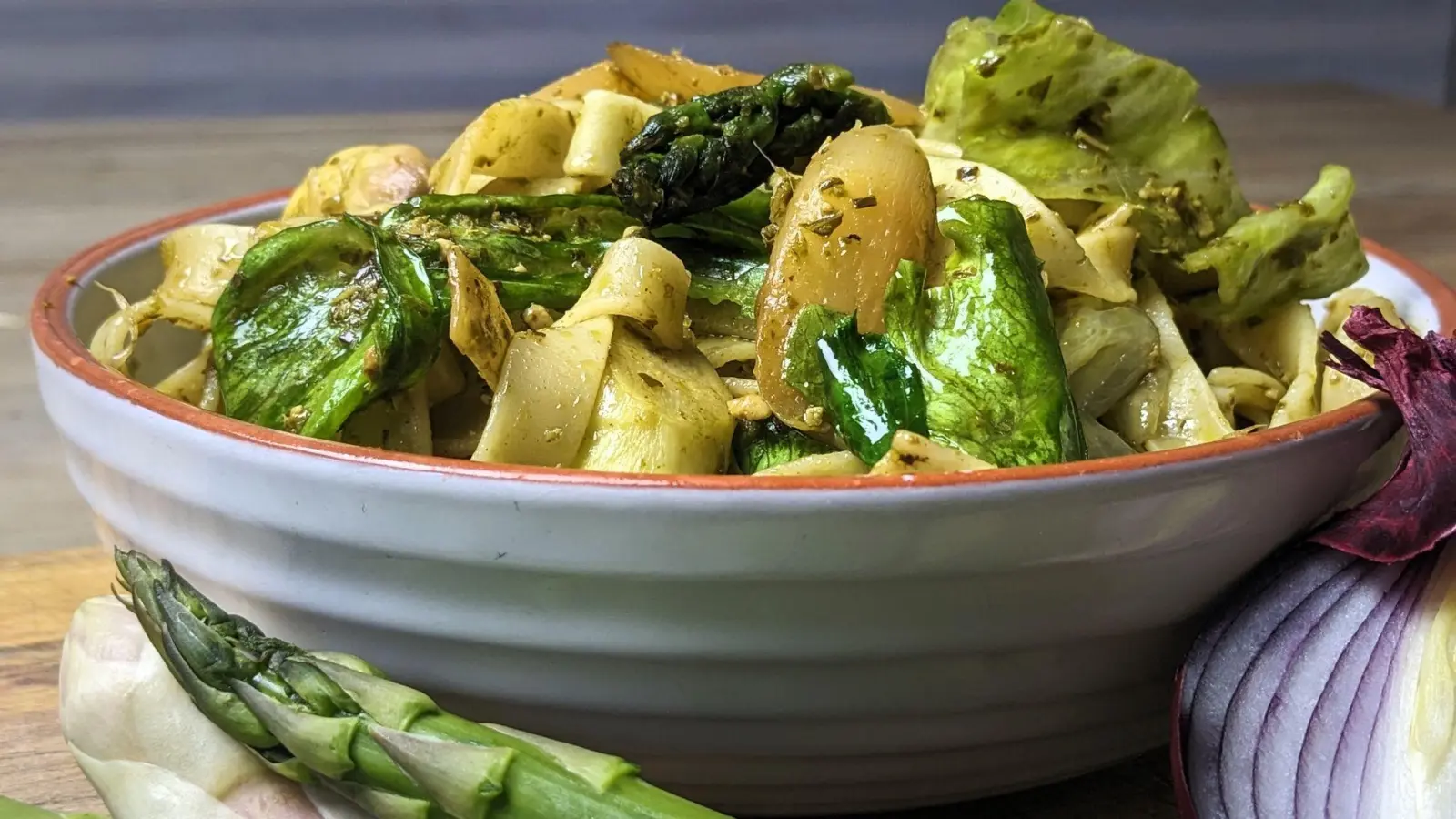 Spargel und Eisbergsalat verpassen der Pasta eine tolle grüne Farbe, Pesto, Zwiebel und Schinkenwürfel die passende Würze. (Foto: Doreen Hassek/haupstadtkueche.blogspot.com/dpa-tmn)