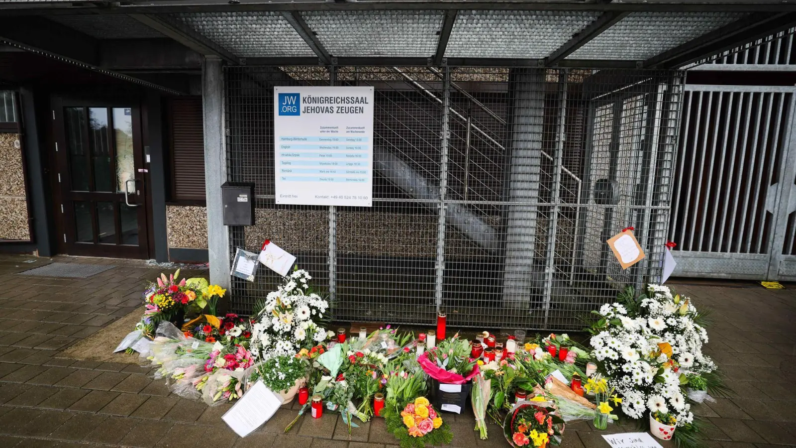 Blumen und Kerzen vor dem Eingangsbereich des Gemeindehauses der Zeugen Jehovas. (Foto: Christian Charisius/dpa)