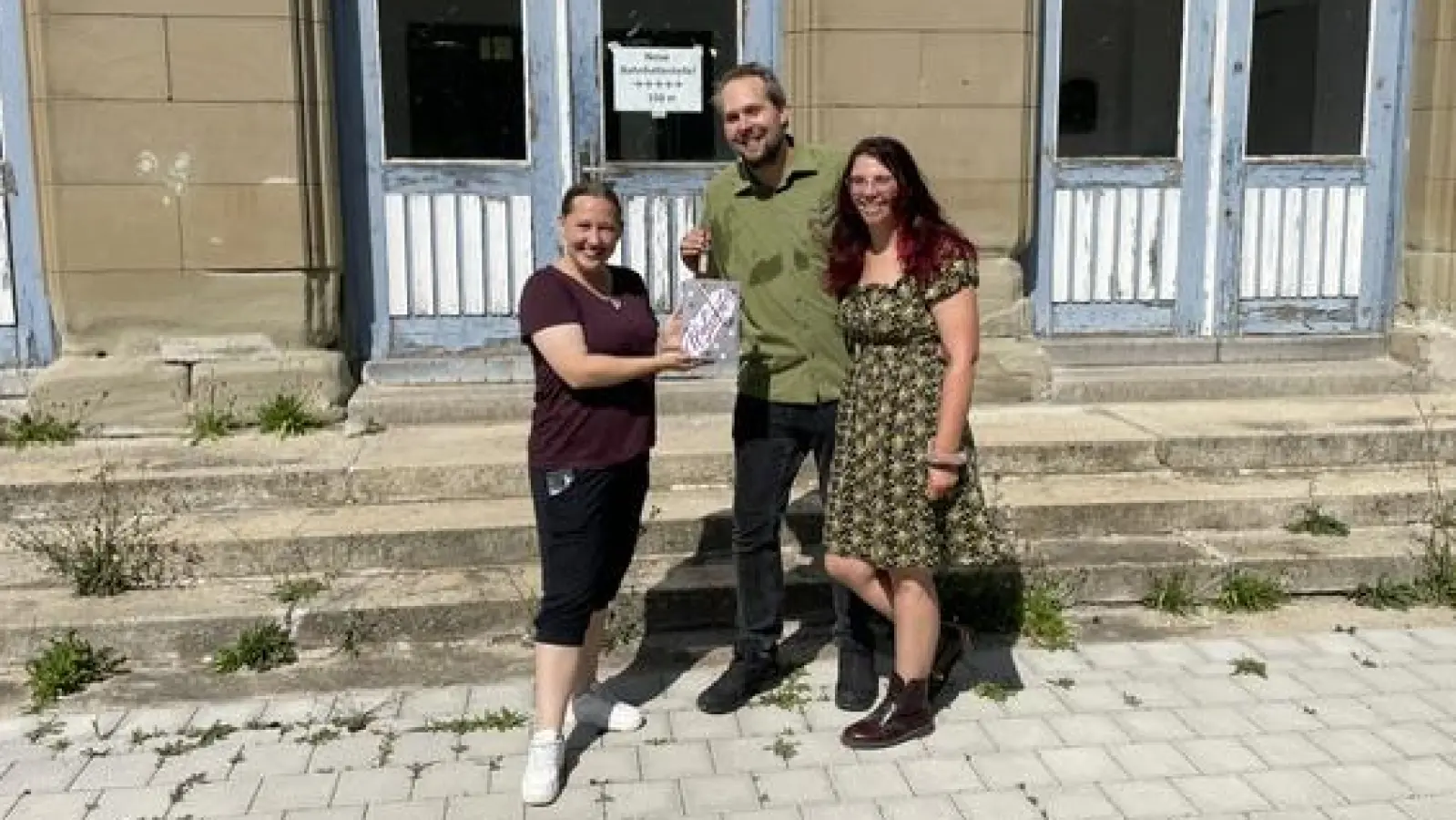 Eileen Gillwald (links) bei der Schlüsselübergabe mit den neuen Eigentümern des ehemaligen Bahnhofsgebäudes, Cato Bohlens und Laura Wilhelm. (Foto: Bernd Käser)