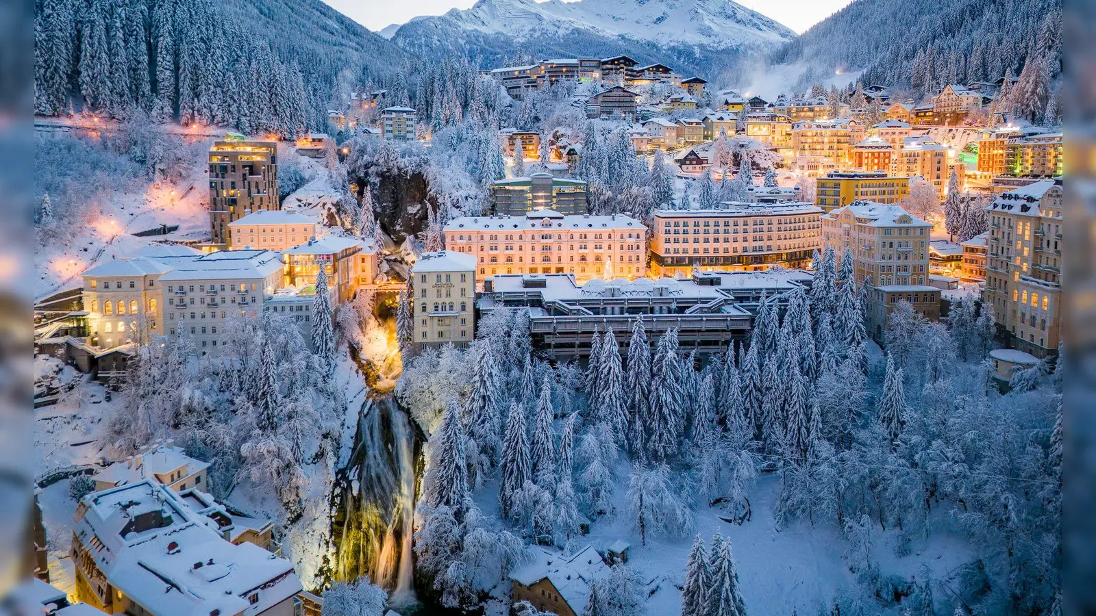 Am Talausgang an einem Wasserfall gelegen: das winterliche Bad Gastein in der Dämmerung. (Foto: Christoph Oberschneider/Gasteinertal Tourismus GmbH/dpa-tmn)