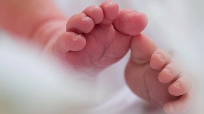 Ein Säugling liegt in einem Bett auf der Wochenstation. (Foto: Arno Burgi/dpa-Zentralbild/dpa)