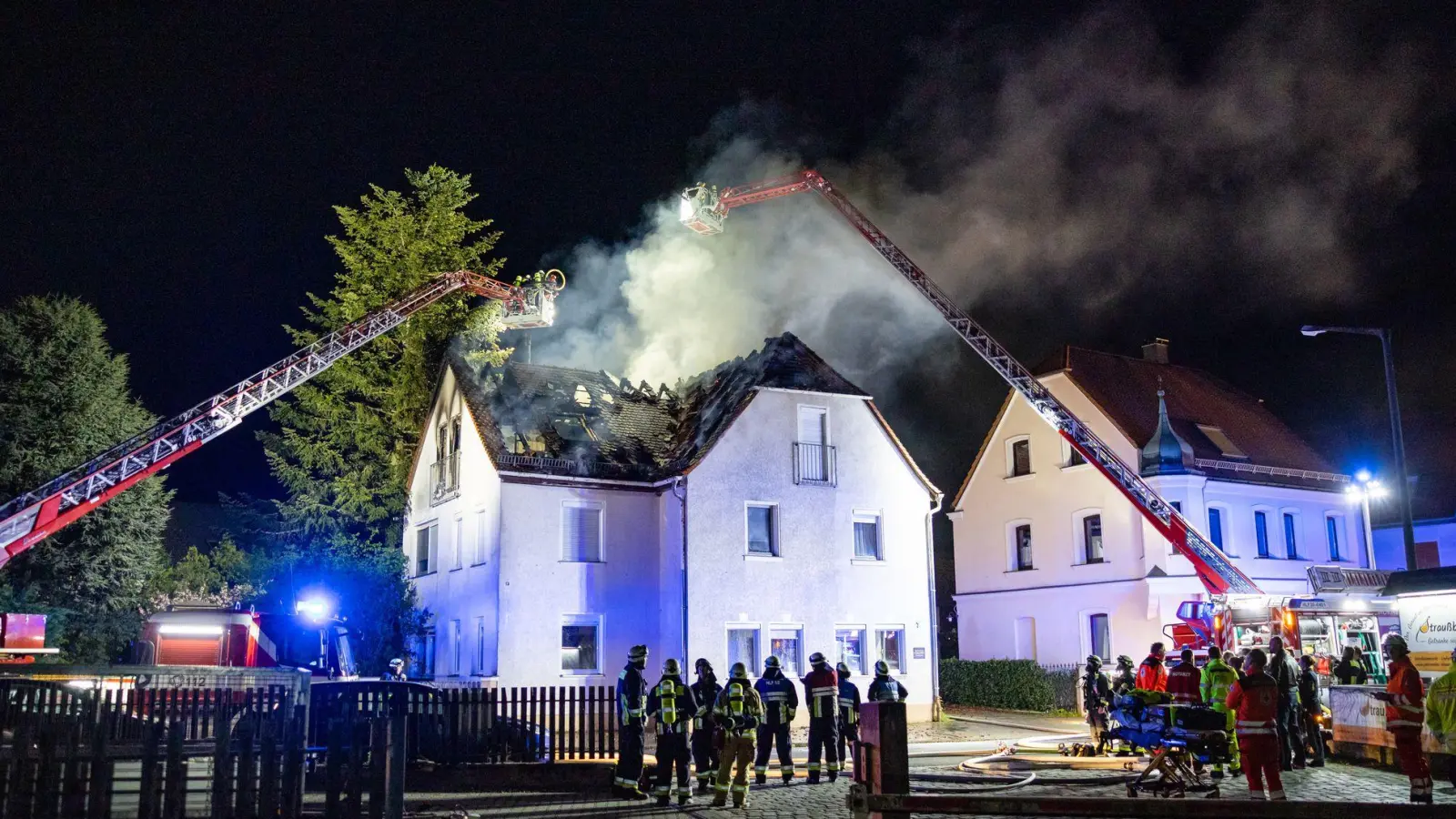 Einsatzkräfte der Feuerwehr sind mit einer Drehleiter am Brand eines Dachstuhls in Nürnberg beschäftigt. (Foto: David Oßwald/NEWS5/dpa)
