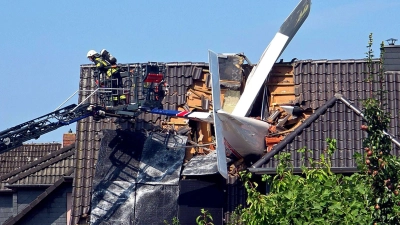 Das Leichtflugzeug stürzte in der Wohnsiedlung in das Dach.  (Foto: Fotoreport-DB/NWM-TV/dpa)