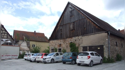 Die Roßmühle soll durch einen Neubau in Verlängerung des Bestandsgebäudes erweitert werden. Entstehen soll ein Zentrum für Physio- und Bewegungstherapie. Derzeit wird die Fläche noch von der Diakonie als Parkplatz genutzt. (Foto: Jasmin Kiendl)