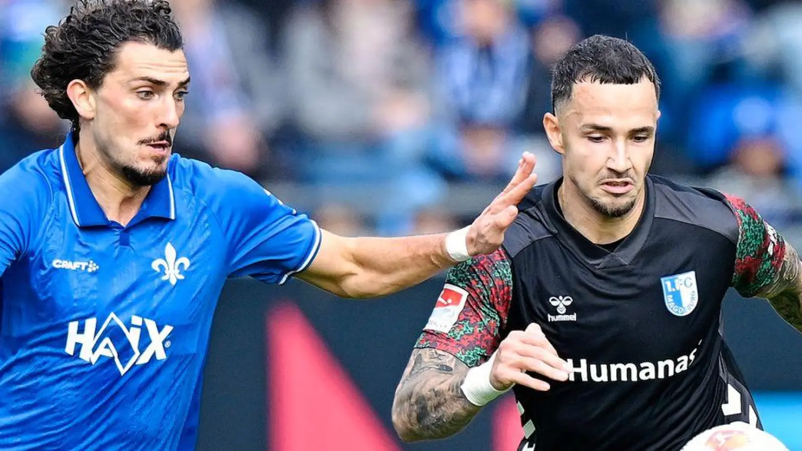 Viel Mittelfeld-Kampf beim Zweitliga-Duell in Darmstadt. (Foto: Uwe Anspach/dpa)