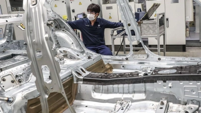 Ein Mann arbeitet im Tiexi-Werk in China von BMW Brilliance Automotive (BBA). (Foto: Pan Yulong/XinHua/dpa/Archiv)