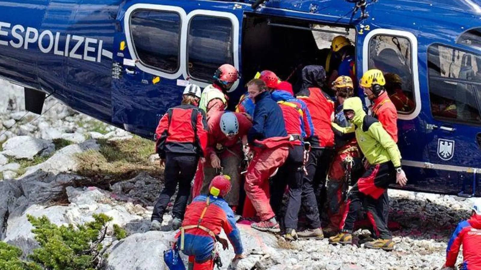 Rettungskräfte tragen am 19.06.2014 am Untersberg bei Marktschellenberg (Bayern) nahe des Einstiegs der Riesending-Schachthöhle den verletzten Höhlenforscher Johann Westhauser auf einer Trage in einen Helikopter der Bundespolizei. (Foto: Nicolas Armer/dpa)