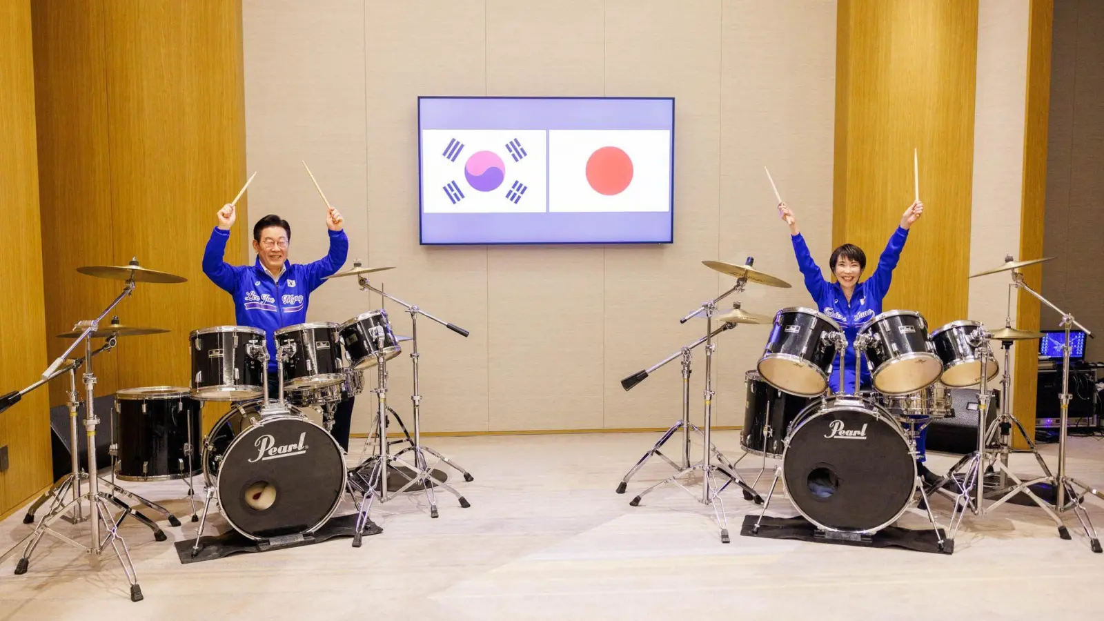 Die japanische Ministerpräsidentin Sanae Takaichi (r) und der südkoreanische Präsident Lee Jae Myung spielen Schlagzeug. (Foto: Uncredited/Prime Minister's Office of Japan/AP/dpa)