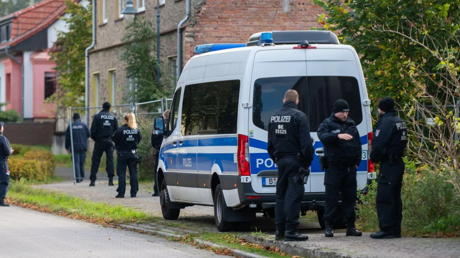 Polizisten stehen vor einem Grundstück in Herzberg. (Foto: Christophe Gateau/dpa)