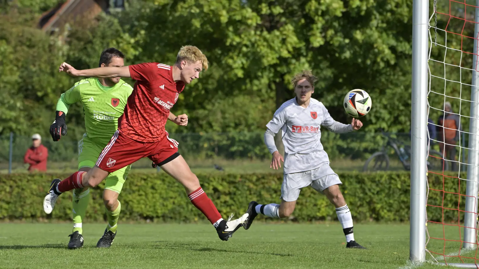 Mit Köpfchen: Der Neuendettelsauer Sven Krug (vorne) erzielt hier die 2:1-Führung gegen den SC Aufkirchen (links Torwart Tim Friedrich, rechts Daniel Meyer). (Foto: Martin Rügner)