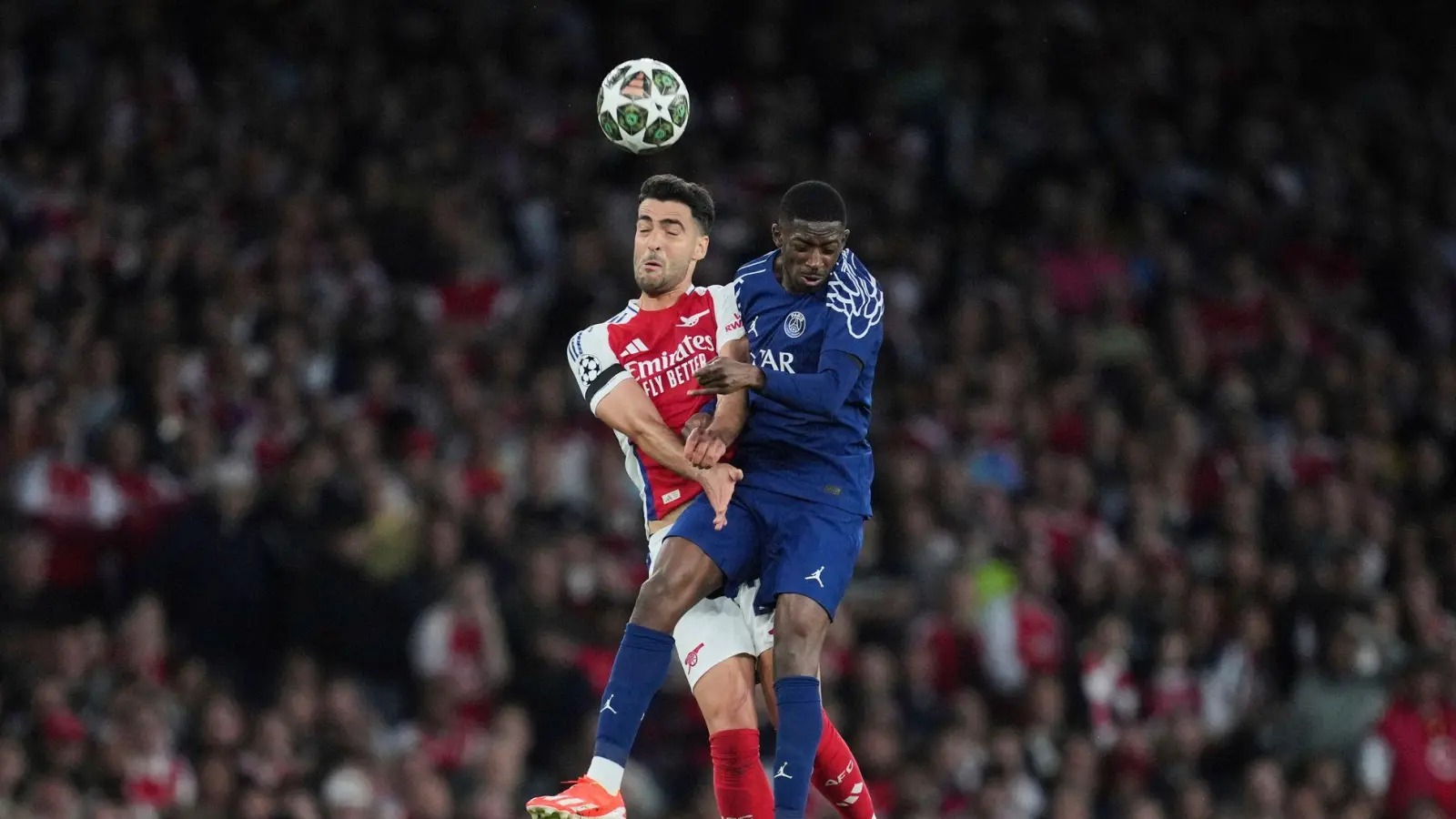 Ousmane Dembélé (r) von Paris Saint-Germain hat sich in der Partie gegen den FC Arsenal leicht verletzt. (Foto: Kin Cheung/AP/dpa)