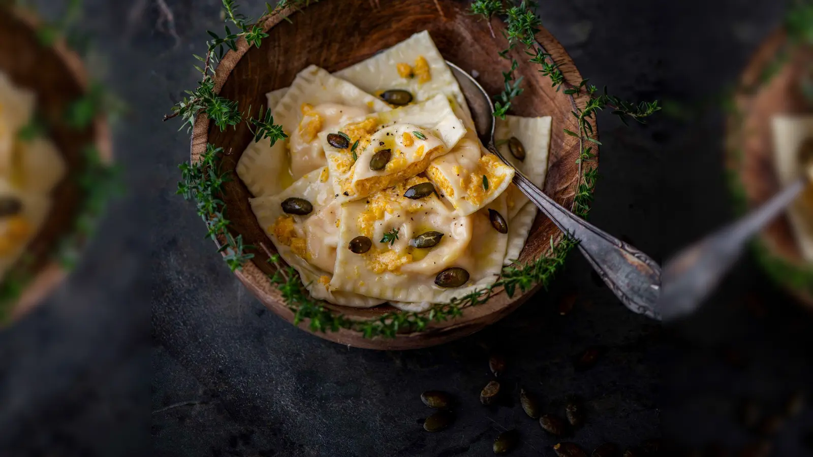 Einen Teil der Kürbis-Ricotta-Mischung wird zum Servieren über die Ravioli verteilt und mit gerösteten Kürbiskernen und Parmesan getoppt. (Foto: Valerie Hammacher/ars vivendi/dpa-tmn)