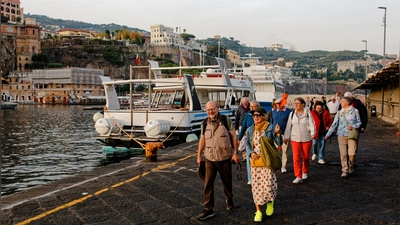 Die Reiseleiterin Viktoria Laszlo führt die Reisenden entlang des Hafens der Halbinsel zu deren Fähre. Viele der Fahrten in Richtung Neapel oder Capri werden hier mit dem Schiff gemacht, da Landwege oft zu lange dauern. (Foto: Tizian Gerbing)