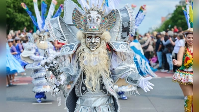 Verkleidete Menschen tanzen zur Musik beim Straßenumzug zum 27. Karneval der Kulturen in Berlin. (Foto: Annette Riedl/dpa)