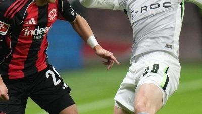Lieferten sich eine umkämpfte Partie: Eintracht Frankfurt um Ritsu Doan (l) und der VfL Wolfsburg um Patrick Wimmer (r). (Foto: Thomas Frey/dpa)