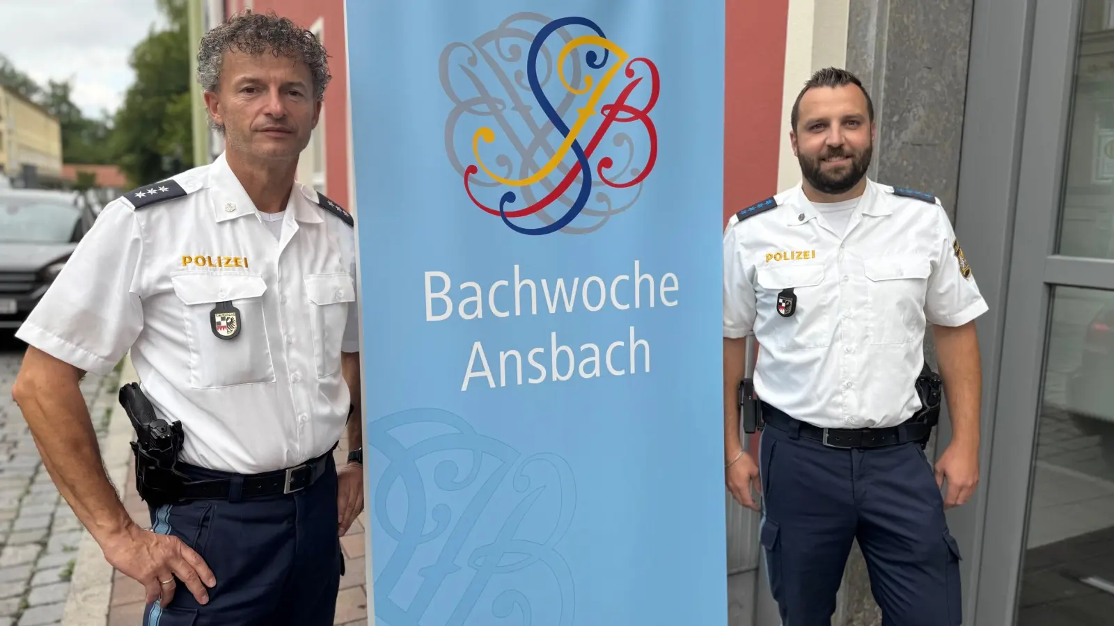 Das Bachwochen-Duo der Polizei: Achim Lindner (link) und Tim Budaker. Die beiden Verkehrserzieher kümmern sich um Straßensperrungen und Sicherheit, stehen den Gästen aber auch mit Rat und Tat zur Seite. Zum Beispiel bei Fragen nach Parkplätzen – oder nach Cafés und Restaurants.  (Foto: Lara Hausleitner)