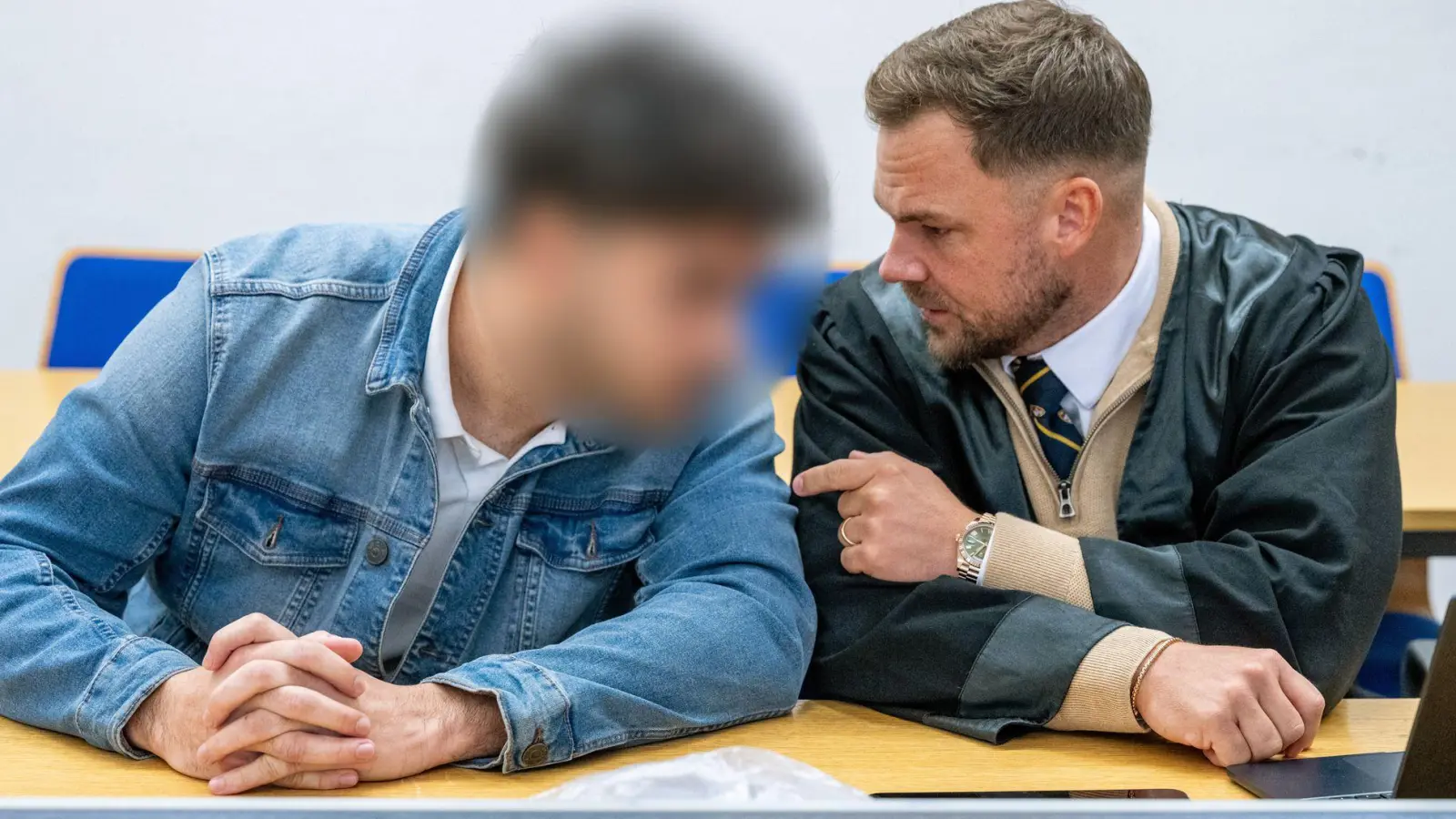Der 28-Jährige spricht im Verhandlungssaal des Landshuter Landgerichts mit seinem Verteidiger André Miegel. (Foto: Armin Weigel/dpa)
