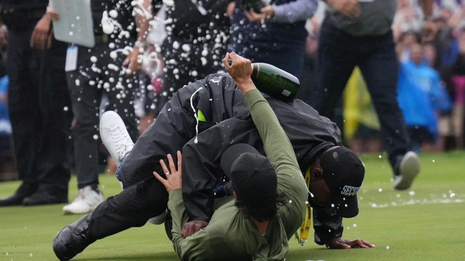 Golfprofi Adam Hadwin (u) wurde von einem Sicherheitsbeamten zu Boden gebracht. (Foto: Nathan Denette/Canadian Press via ZUMA Press/dpa)