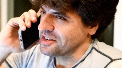 Karl Deisseroth, einer der drei Preisträger des Nobelpreises für Medizin 2026, telefoniert  zu Hause in Stanford, Kalifornien, mit seinem Handy. (Foto: Noah Berger/AP/dpa)