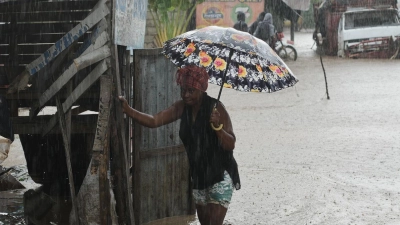 Anwohner waten durch eine überflutete Straße nach dem durchzug von Hurrikan Melissa in Petit-Goave. (Foto: Odelyn Joseph/AP/dpa)