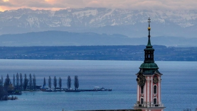 Hinter der ehemaligen Klosterkirche Birnau am Bodensee geht die Sonne auf. Die Alpen sind im Hintergrund zu sehen. (Foto: Felix Kästle/dpa)