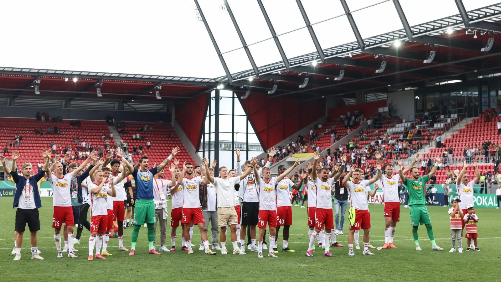 Die Fußballer von Jahn Regensburg jubeln nach der Pokal-Überraschung gegen Bochum. (Foto: Stefan Bösl/dpa)