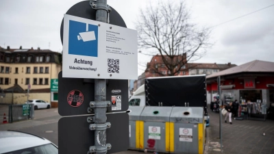 Schilder weisen auf die Videoüberwachung an den Glascontainern in der Nürnberger Südstadt hin. Dabei handelt es sich um ein Pilotprojekt.  (Foto: Daniel Vogl/dpa)